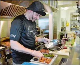  ?? TIM MARTIN/THE DAY ?? Jose L. Martinez of New London, chef and co-owner of the Thames Landing Oyster House at 2 State St. in New London, prepares coconut shrimp with a plum sauce on Friday.