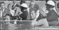  ?? The Associated Press ?? JFK FILES: In this Nov. 22, 1963, photo, President John F. Kennedy waves from his car in a motorcade in Dallas. Riding with Kennedy are First Lady Jacqueline Kennedy, right, Nellie Connally, second from left, and her husband, Texas Gov. John Connally,...