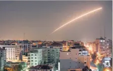  ?? — AFP ?? Israeli missile launched from the Iron Dome defence missile system is seen above Gaza city.