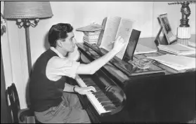  ??  ?? In this Feb. 24, 1945 photo, conductor, composer and pianist Leonard Bernstein works on a new musical score in his West side apartment in New York City.