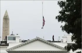  ?? Getty Images ?? A U.S. Secret Service officer lowers the American flag to half staff over the White House on Tuesday in Washington.