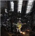  ?? ?? A forensic archaeolog­ist inspects the charred remains of the Mackintosh Library