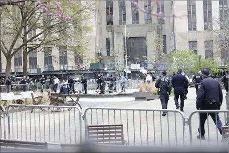  ?? MICHAEL M. SANTIAGO — GETTY IMAGES/TNS ?? Paramedics attend to a person who apparently self-immolated near Manhattan Criminal Court on April 19, 2024, in New York City. First responders extinguish­ed the flames of an unknown person outside of the courthouse where former President Trump is facing 34felony counts of falsifying business records in the first of his criminal cases to go to trial.