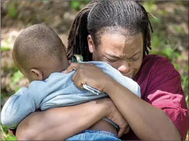  ?? Arkansas Democrat-Gazette/BENJAMIN KRAIN ?? Chris Maxwell clutches his child Thursday afternoon after retrieving him from police at 1805 Park Lane, where his aunt, who operated the day care, died in a drive-by shooting. Police said the 57-year-old woman was killed by a stray shot when a...