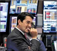  ?? AP/RICHARD DREW ?? Trader Mark Muller watches Thursday on the floor of the New York Stock Exchange as stocks plummet amid fears that chances for a recession are larger than experts previously thought.