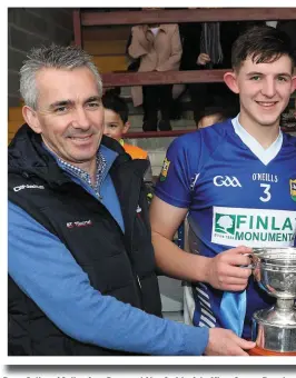  ??  ?? Barry Cullen of Cullen Auto Parts and Alan Smith of the Minor County Board with the trophy.