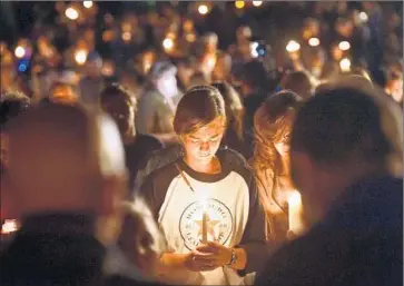 ?? Josh Edelson AFP/Getty Images ?? RESIDENTS OF Roseburg gathered for a vigil Thursday night for those slain and wounded at Umpqua Community College, where many older students study as they embark on new career paths.