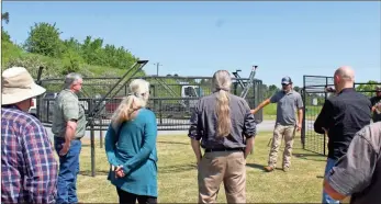  ?? Blake Silvers ?? US Department of Agricultur­e wildlife biologist and feral swine coordinato­r Matt Ondovchik, right, demonstrat­es a feral swine trap at a workshop at the Gordon County Agricultur­al Service Center, 1282 GA-53 Spur.