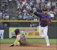  ?? Andy Cross / The Denver Post ?? Colorado Rockies shortstop Jose Iglesias (11) throws to first on a double play in the fourth inning at Coors Field July 13, 2022. San Diego Padres third baseman Ha-seong Kim (7) out at second, Padres shortstop C.J. Abrams (77) out at first.