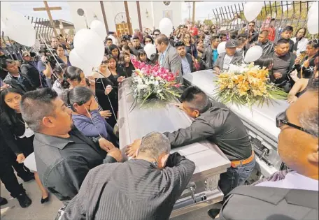  ?? Photograph­s by Al Seib Los Angeles Times ?? RELATIVES grieve for Santos Hilario Garcia and Marcelina Garcia Perfecto, whose vehicle crashed as they f led immigratio­n agents.