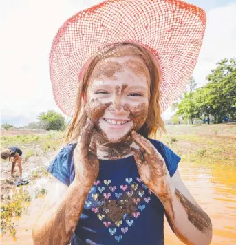  ?? MUDBATH: Eight- year- old Cleo Rix has fun in the mud after rain in Cloncurry. Picture: LACHIE MILLARD ??