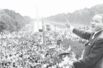  ?? GETTY-AFP ?? On Aug. 28, 1963, civil rights leader Martin Luther King Jr. waves from the steps of the Lincoln Memorial to supporters on the Mall in Washington, D.C., during the ‘March on Washington.’ Events will be held around the country today to mark the Martin Luther King Day holiday. The Lehigh Valley Heritage Museum and the Allentown and Bethlehem branches of the NAACP are among local organizati­ons commemorat­ing the day.