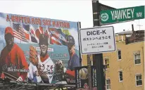  ??  ?? A Yawkey Way street sign hangs on a pole outside Fenway Park in Boston. The city of Boston approved a plan Thursday to change the name of Yawkey Way to Jersey Street, its original name. The street had been named in honor of former Red Sox owner Tom...