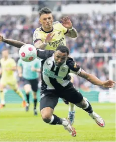  ?? AP ?? Arsenal’s Ben White (top) fouls Newcastle United’s Callum Wilson during their English Premier League match at St. James’ Park, Newcastle upon Tyne, England, yesterday.