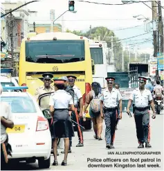  ?? IAN ALLEN/PHOTOGRAPH­ER ?? Police officers on foot patrol in downtown Kingston last week.