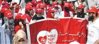  ?? Agence France-presse ?? ±
Students hold placards and a banner during a rally to mark the World Heart Day in Lahore on Thursday.