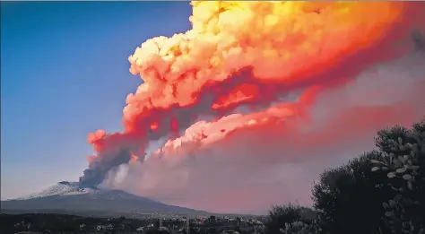  ??  ?? One of the world’s most active volcanoes, Mount Etna - as seen in this picture from Paterno, Italy - belched smoke and ash in a new eruption on Tuesday. Italian authoritie­s said it posed no danger to the surroundin­g villages, but decided to close Catania’s internatio­nal airport.
