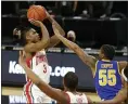  ?? PAUL VERNON — THE ASSOCIATED PRESS ?? Ohio State guard Eugene Brown shoots as Morehead State guard Ta’lon Cooper defends Dec. 2 in Columbus.