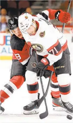  ?? GETTY ?? Senators’ Chris Tierney and Dawson Mercer of Devils fight for puck in Ottawa’s shootout victory Monday night in Newark.