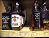  ??  ?? A file photo shows whiskeys distilled and bottled in the US are displayed for sale in a grocery store in Beijing.
— Ti Gong