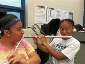  ?? ZACH SRNIS — THE MORNING JOURNAL ?? Alyssa Ruiz, 16, and Margaret Otero, 15, both sophomores at Lorain High School, practice the flute ahead of the upcoming parade.