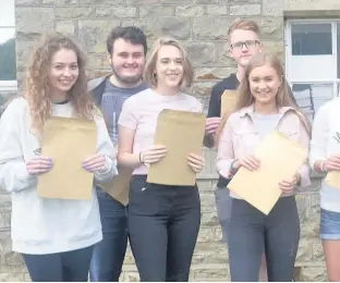  ??  ?? Students at Brynteg School in Bridgend celebrate their A-level results
