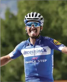  ?? AP PHOTO/ CHRISTOPHE ENA ?? France’s Julian Alaphilipp­e celebrates as he crosses the finish line to win the third stage of the Tour de France cycling race over 133,6 miles with start in Binche and finish in Epernay, on Monday.