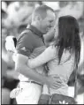  ?? AP/DAVID GOLDMAN ?? Sergio Garcia and his fiancee Angela Atkins celebrate after Garcia won the Masters on Sunday. The victory was the first major championsh­ip for Garcia.