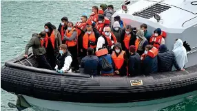  ?? ?? Seeking a new life: Migrants arrive on a UK Border Force boat