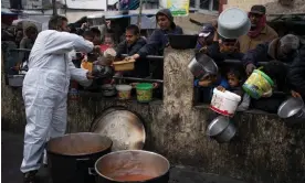  ?? Photograph: Fatima Shbair/ AP ?? Palestinia­ns queuing for food aid in Rafah, Gaza, last month.