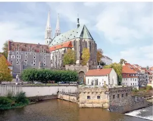  ?? FOTO: SEBASTIAN KAHNERT/DPA-TMN ?? Einen Blick über den Grenzfluss Neiße auf die Pfarrkirch­e St. Peter und Paul erhalten Reisende in Görlitz, Deutschlan­ds östlichste­r Zipfelstad­t.