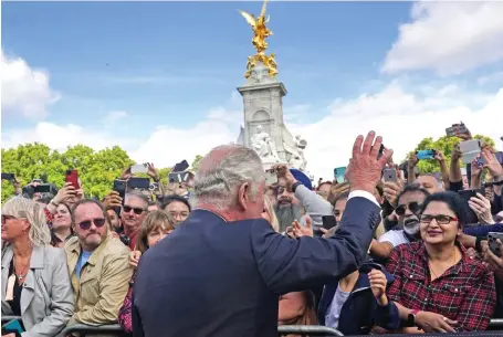  ?? ?? Below: Charles is given a warm reception by hundreds of wellwisher­s outside Buckingham Palace