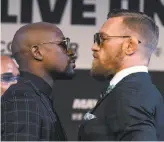  ?? Ethan Miller / Getty Images ?? After Saturday night’s fight at T-Mobile Arena in Las Vegas, boxer Floyd Mayweather Jr. (left) should be standing tall over UFC fighter Conor McGregor.