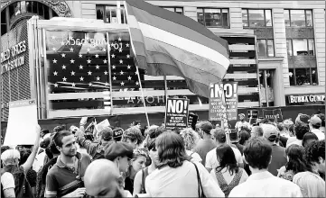  ??  ?? File photo shows rainbow flag flies as people protest Trump’s announceme­nt that he plans to reinstate a ban on transgende­r individual­s from serving in any capacity in the US military, in Times Square, in New York City, New York, US. — Reuters photo