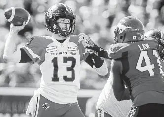  ?? CANADIAN PRESS FILE PHOTO ?? B.C. Lions quarterbac­k Mike Reilly, left, throws the ball as Calgary Stampeders' Cordarro Law closes in in Canadian Football League play last month. Reilly has shared his mental-health woes, hoping it helps others.