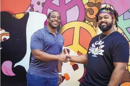  ?? IVY CEBALLO/TAMPA BAY TIMES ?? Franchise partners Eric Taylor, left, and Antonio McBroom stand outside the Midtown Tampa, Florida, Ben & Jerry’s when it was under constructi­on in 2021. Their partnershi­p includes the first Black-owned franchises in Florida.