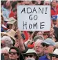  ?? PHOTO: REUTERS ?? A protester holds a sign as he participat­es against Adani’s coal mine project in Australia