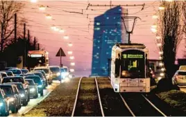  ?? MICHAEL PROBST/AP ?? A tram passes traffic as it heads toward the European Central Bank in Frankfurt, Germany. Eurozone inflation persists but is down from its October peak of 10.6%.