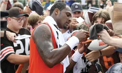  ?? ?? Browns quarterbac­k Deshaun Watson signs autographs for fans at the team’s training camp on Monday in Berea, Ohio. Photograph: Nick Cammett/AP
