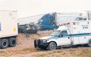  ??  ?? This photo provided by Robert Yacone shows an ambulance at the scene of a 25-vehicle pileup on Interstate 10 near Lordsburg after a blowing dust storm Monday.