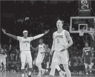  ?? Luis Sinco Los Angeles Times ?? LUKE KENNARD (5) reacts after hitting a three-pointer against the Lakers in December. The Clippers guard is connecting on 43.9% of his three-point attempts, third best in the NBA.