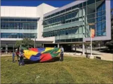  ?? KATHLEEN CAREY – DIGITAL FIRST MEDIA ?? Parachute activities were just one of the big events taking place on the Marple campus near DCCC’s STEM center as part of the 50th anniversar­y celebratio­n at the school Saturday.