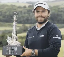  ??  ?? 0 Romain Langasque with the trophy after his Wales Open win.