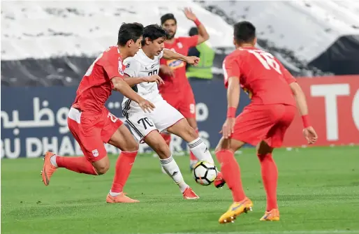  ?? Supplied photo ?? Al Jazira’s Ahmed Al Hashmi tries to control the ball with Tractor Sazi players lurking around him during the AFC Champions League match in Abu Dhabi. —