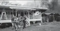  ?? Tamir Kalifa / New York Times ?? Emanuel Roditis is led out of his burning house as lava from Kilauea advances through his property in Pahoa, Hawaii.