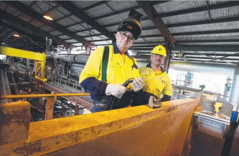 ?? Picture: STEWART McLEAN ?? NO RESPITE: Boiler makers Ron Scarabello and Jason Jerome using the wet weather shutdown for some maintenanc­e work at the Mulgrave sugar mill.