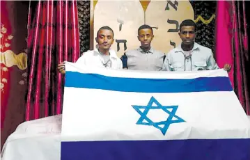  ?? (The Struggle for Ethiopian Aliya) ?? SINTAYEHU SHIFARAW (right) stands with two other finalists for the Internatio­nal Bible Contest at a synagogue in Addis Ababa, Ethiopia.