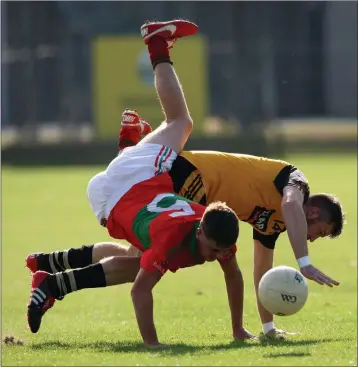  ??  ?? Rathnew’s Jack Healy and Ashford’s Gavin Weir clash during the Darcy Sand Intermedia­te Football Championsh­ip meeting between the sides in Joule Park Aughrim. Photo: Joe Byrne