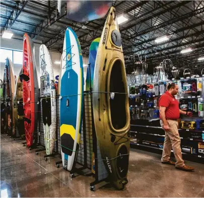  ?? Marie D. De Jesús / Staff photograph­er ?? A kayak display is among the exhibits at the new 63,000-square-foot Academy Sports + Outdoors store in Richmond. “We want to create an emotional experience for our customers,” says executive vice president Sam Johnson.