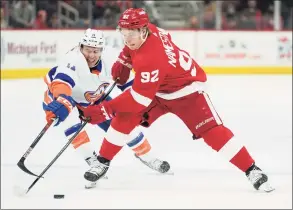  ?? Paul Sancya / Associated Press ?? The Red Wings’ Vladislav Namestniko­v, right, protects the puck from the Islanders’ Zach Parise on Dec. 14. Wednesday’s Red Wings-Islanders game has been postponed.